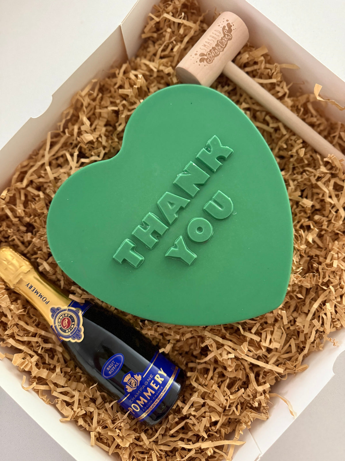 Green heart-shaped Thank You chocolate SmashBox with champagne and wooden hammer